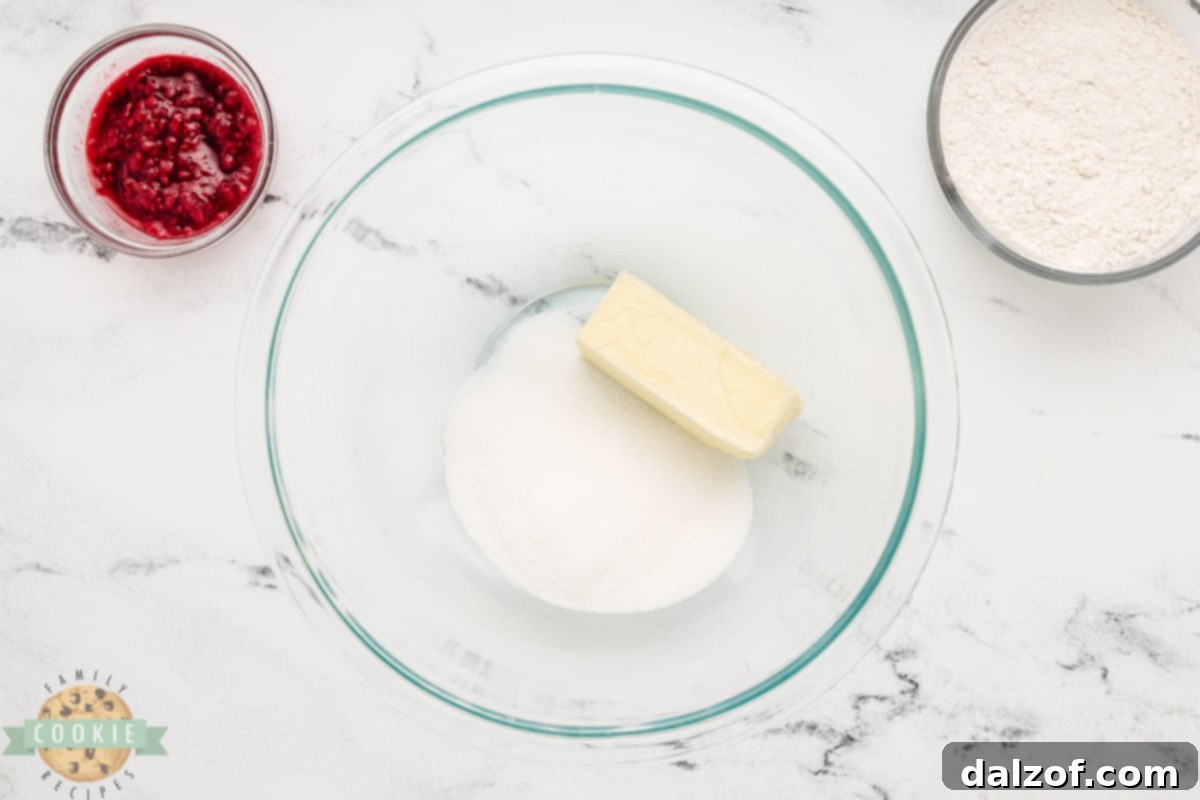 Butter and sugar being creamed together in a mixing bowl, showing the light and fluffy texture.
