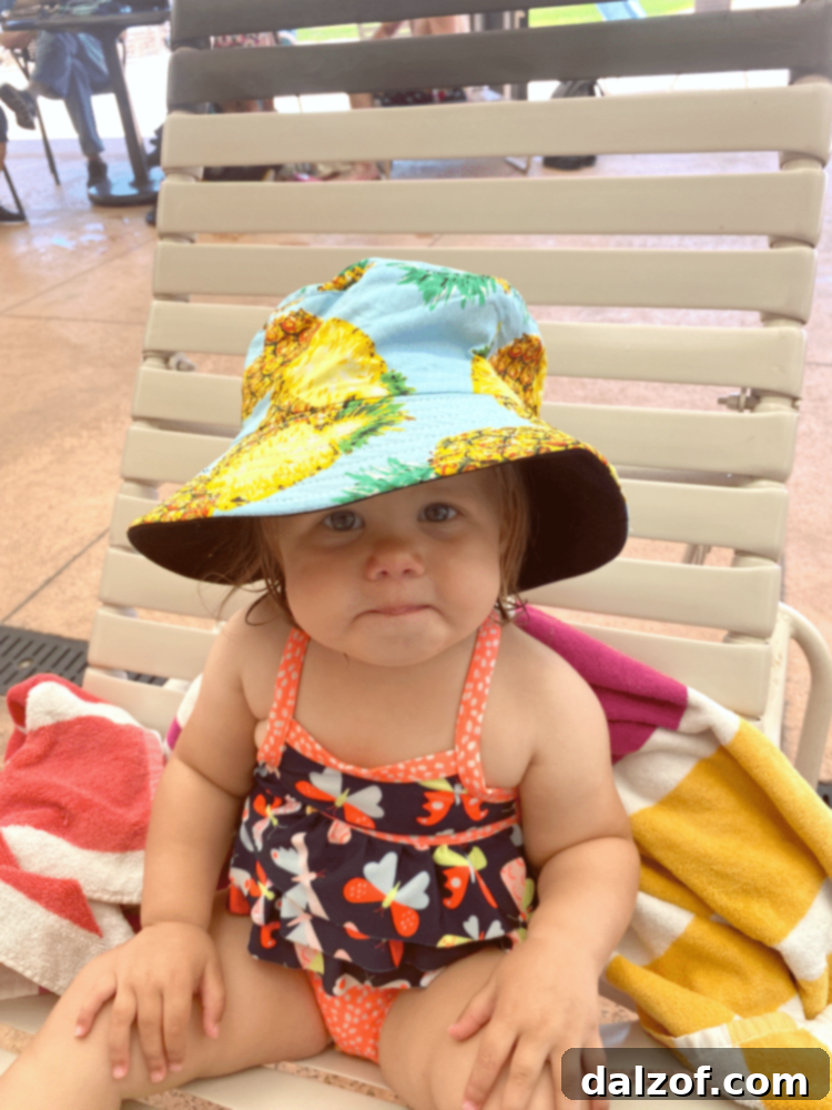 A child happily splashing in a swimming pool, enjoying the summer heat in Utah.