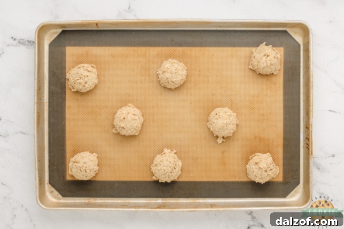 Wholesome Banana Oat Bliss 11 Scoops of Banana Oatmeal Cookie dough on a baking sheet lined with parchment paper