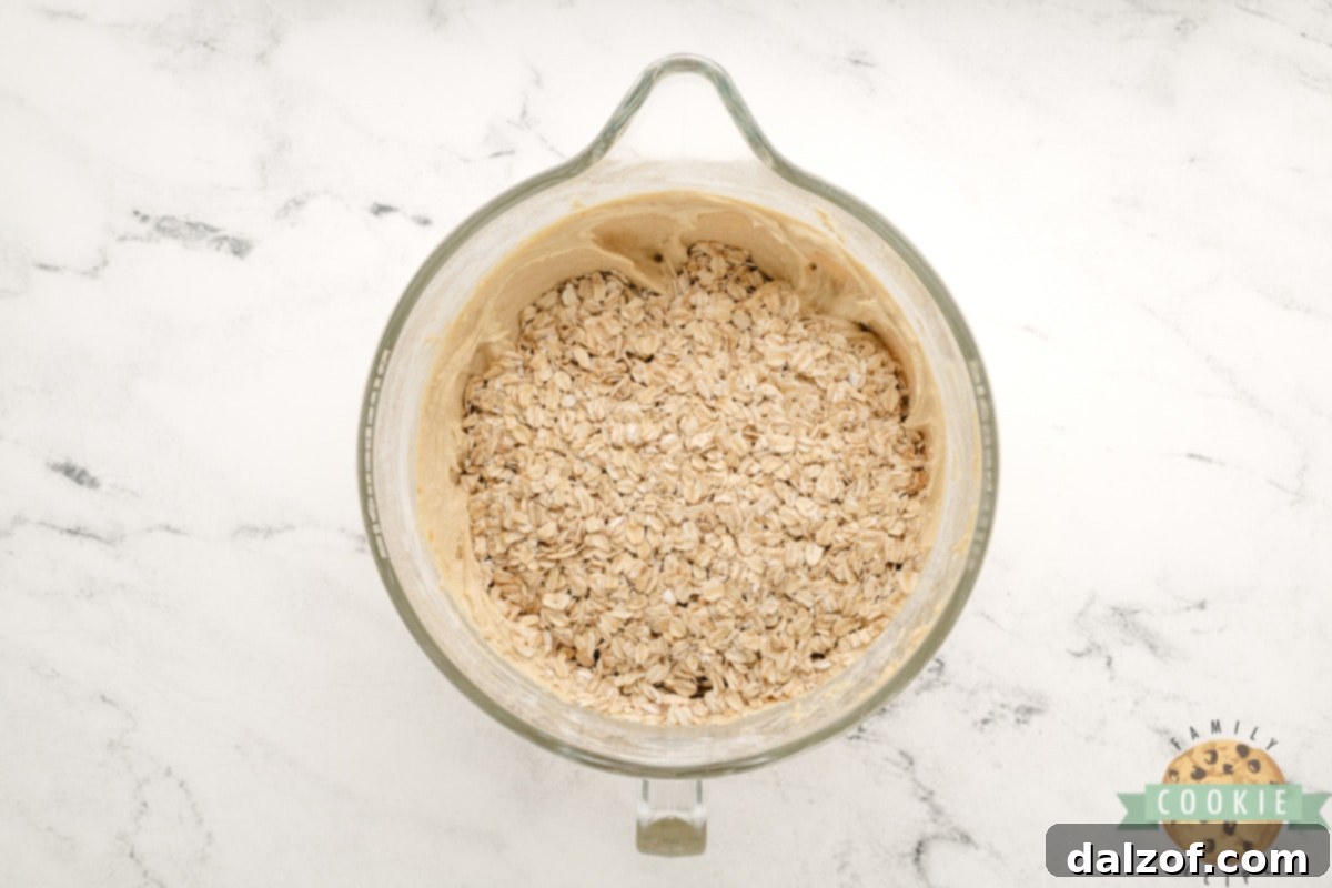 Wholesome Banana Oat Bliss 10 Folding rolled oats into the banana cookie dough with a spoon
