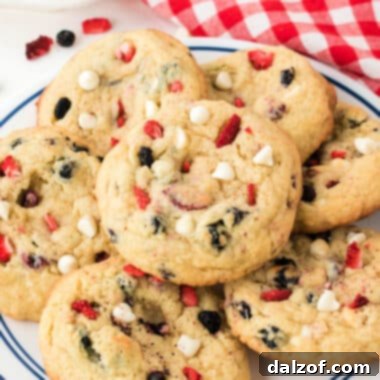 Red, White & Blue Cream Cheese Cookies are soft, chewy, and perfectly patriotic! These delicious cookies are made with freeze-dried blueberries and strawberries that add lots of flavor and the right colors for the 4th of July.