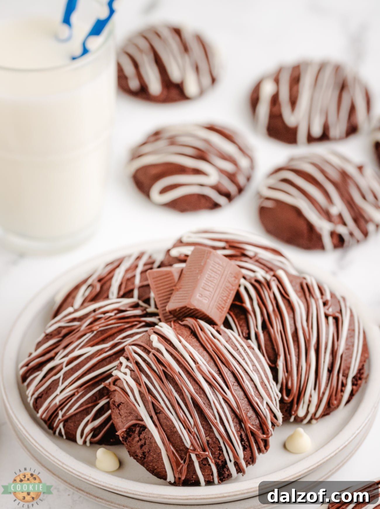 plateful of chocolate stuffed cake mix cookies, some broken open to show the melted chocolate center