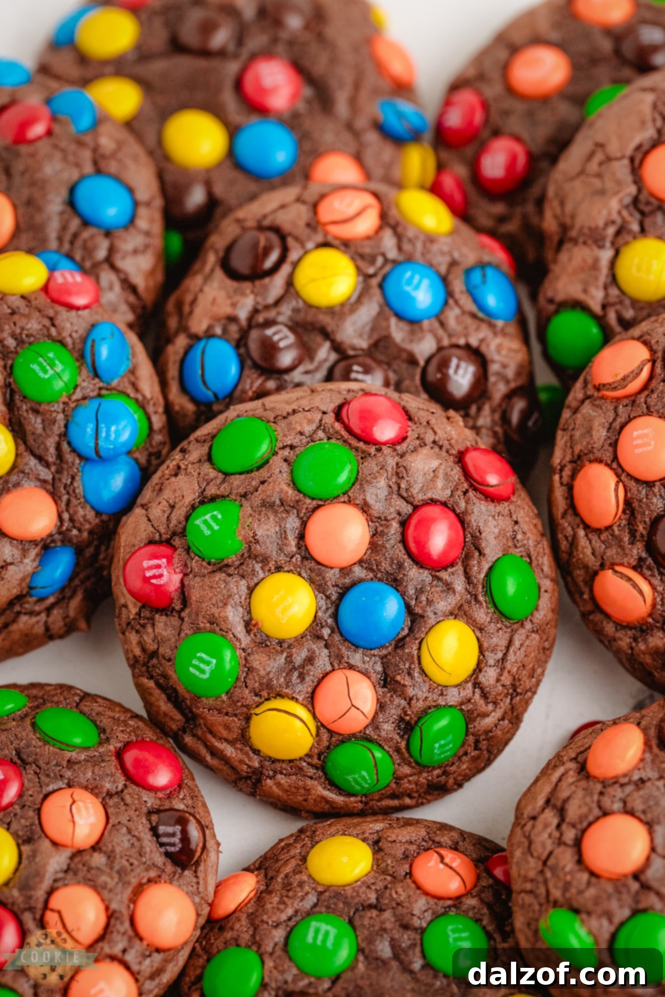 Close-up of a perfectly baked, chewy chocolatey brownie mix cookie topped generously with colorful M&M candies.