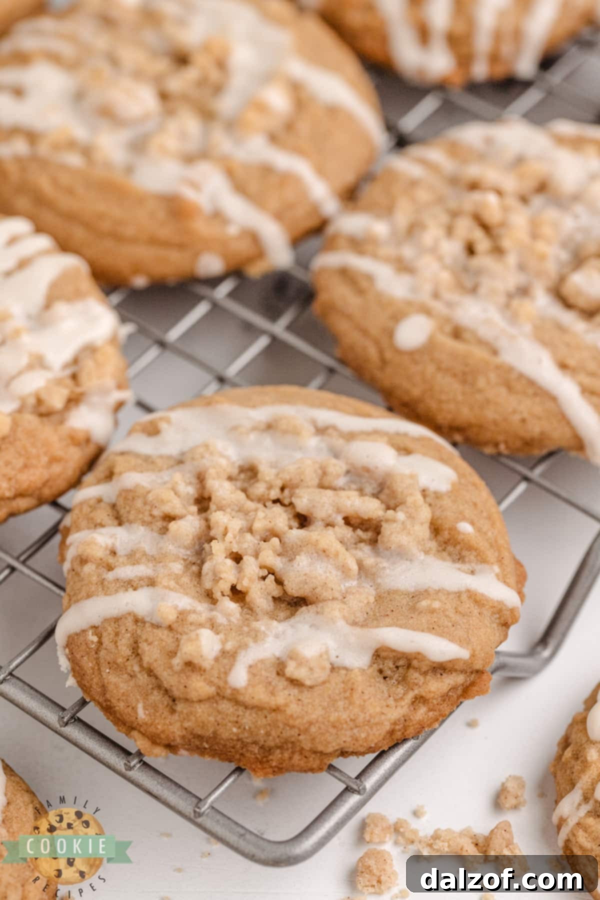 Cinnamon cookie topped with crumb topping and vanilla glaze. 