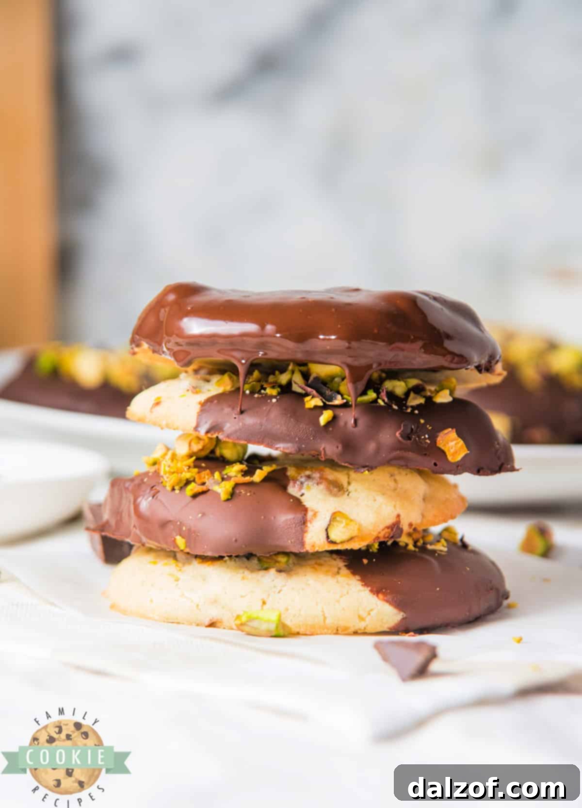 A plate of gourmet Chocolate Dipped Pistachio Cookies, showcasing their delicate texture and elegant chocolate coating.