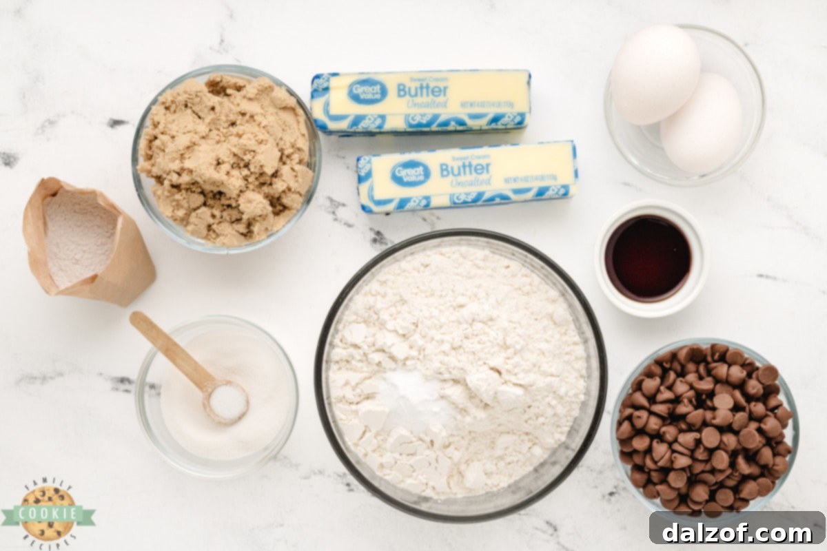 Essential ingredients laid out for Butterscotch Chocolate Chip Cookies, including butter, sugars, pudding mix, eggs, flour, baking soda, and chocolate chips.