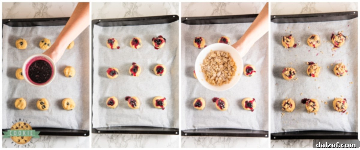 Assembling cookies: adding blueberry jam to the indentation and sprinkling streusel on top.