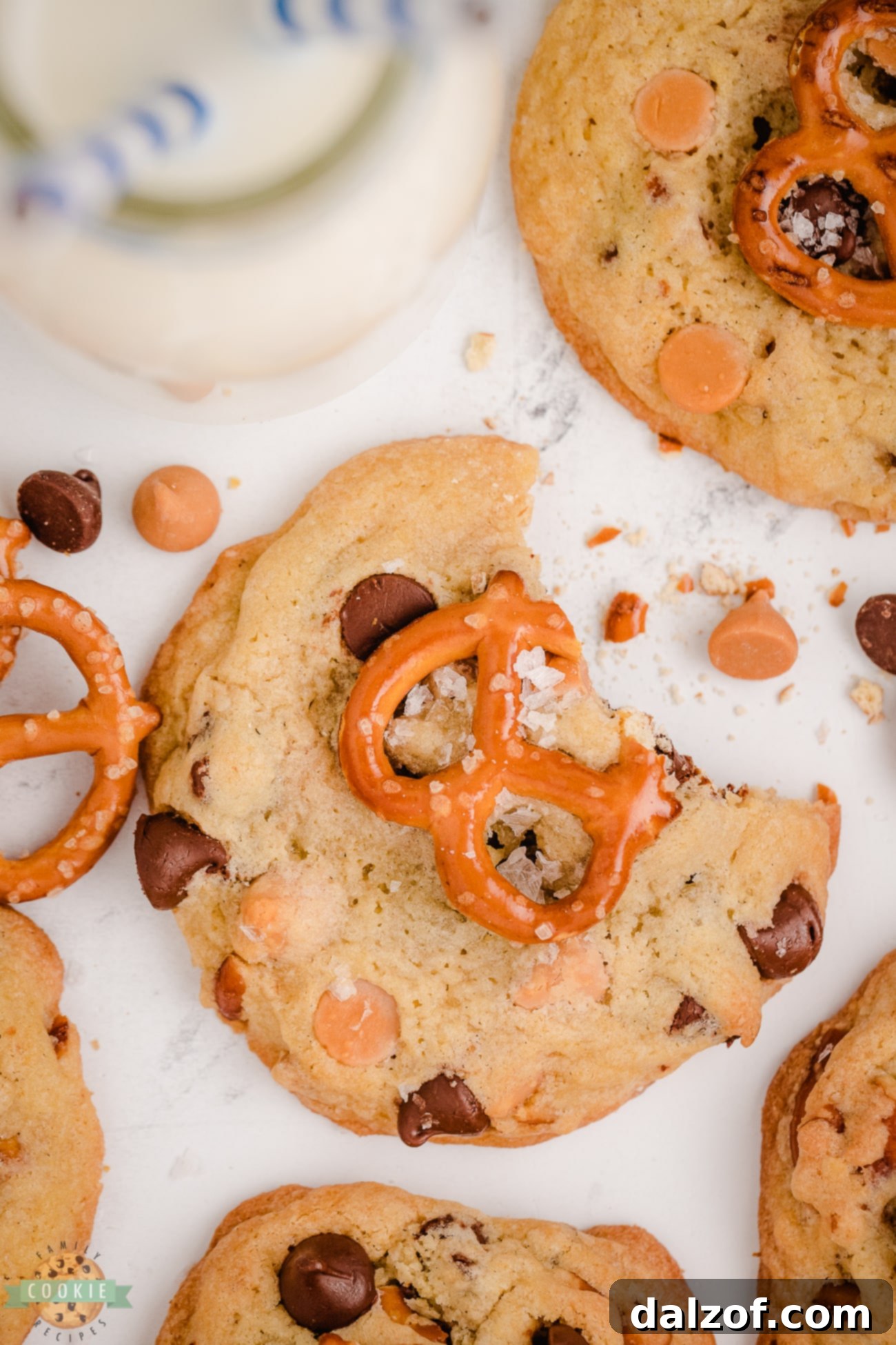 Close-up of a bite taken from a butterscotch cookie with visible pretzels