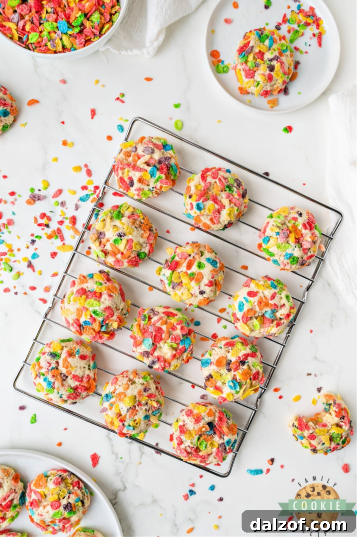 Freshly baked Fruity Pebbles cookies cooling on a wire rack.