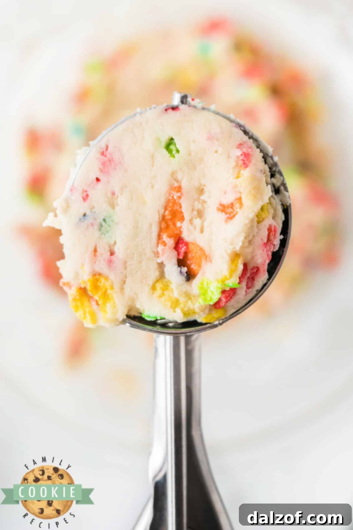 A scoop of cookie dough, ready to be rolled in cereal.