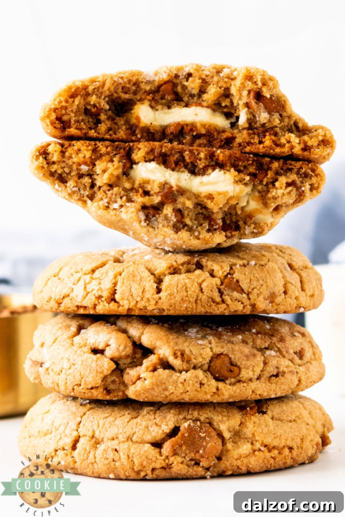 A trio of Biscoff Butter Cookies displayed on a rustic wooden board.
