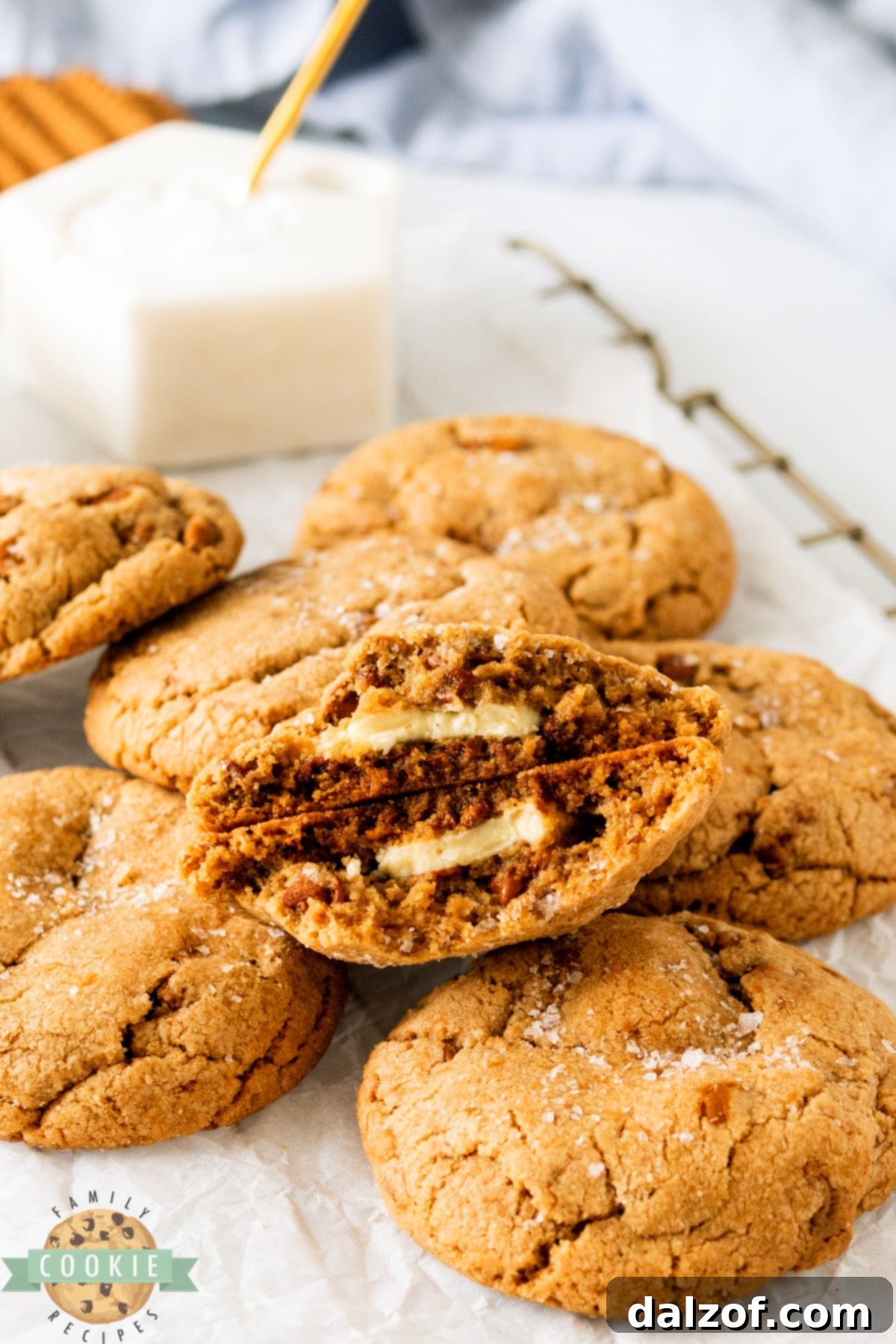 Biscoff Butter Cookies with melted white chocolate centers, casually arranged on a baking sheet.