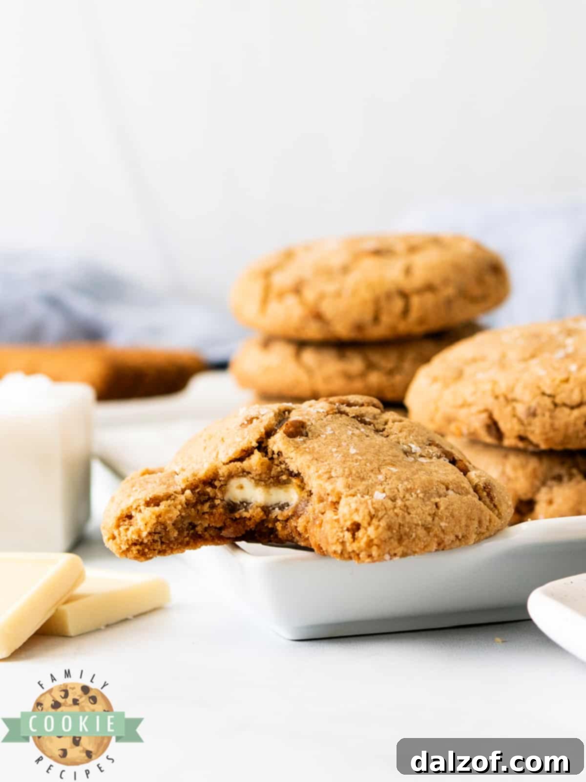 Baked Biscoff Butter Cookies with visible melted white chocolate centers, displayed on a cooling rack.