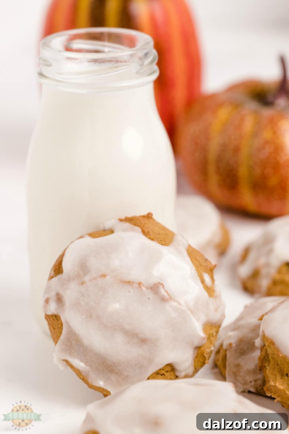 Pillowy soft iced pumpkin cookies with vanilla glaze, a comforting fall treat