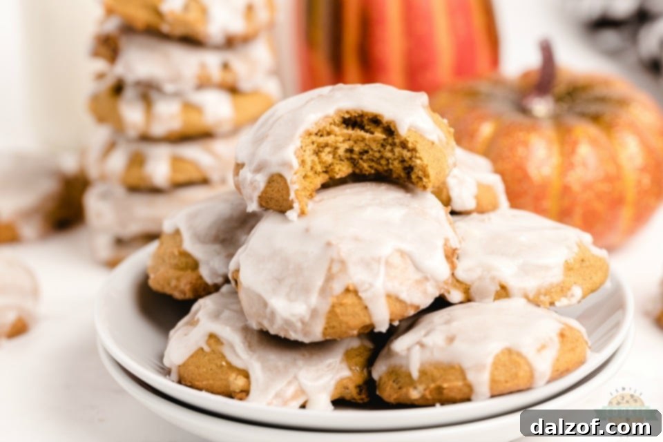 Beautifully decorated iced pumpkin cookies for a festive presentation, customizable with colors and flavors