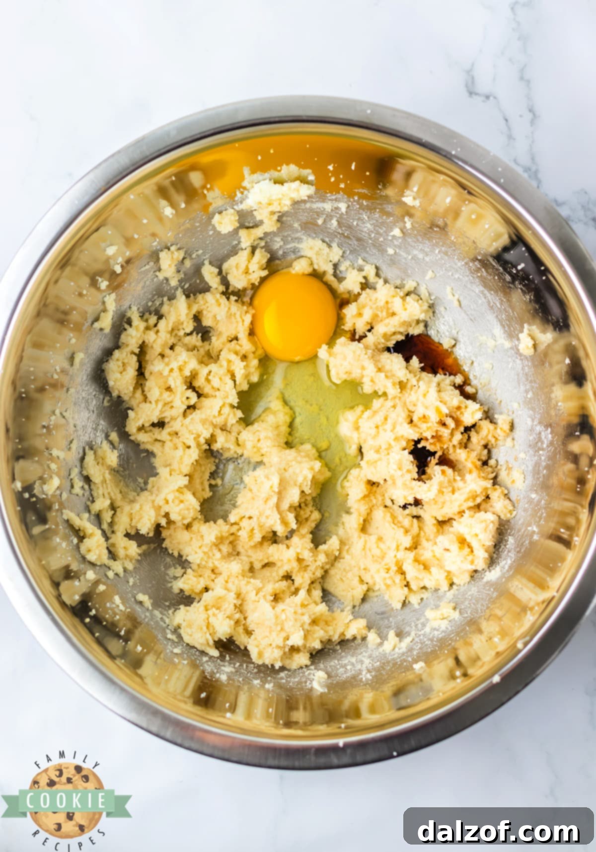 Add egg and vanilla to creamed butter and sugar. 