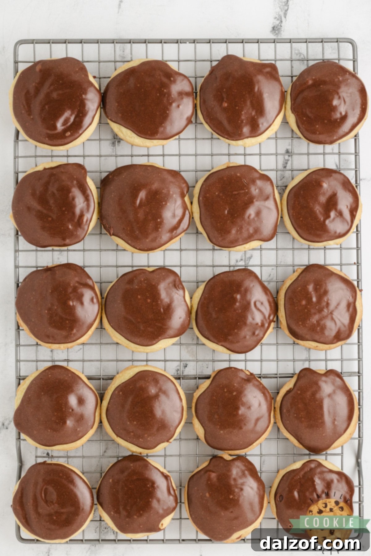 Fudge topping on orange cookies.