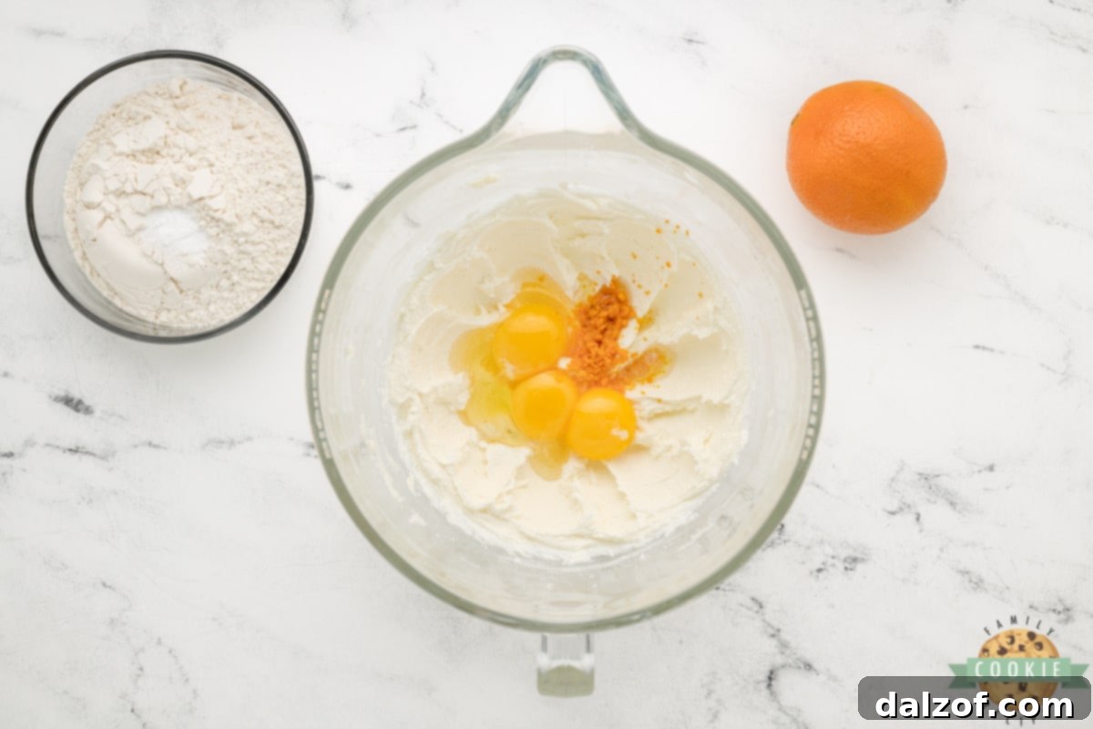 Add egg, egg yolks, orange peel, and orange extract. 
