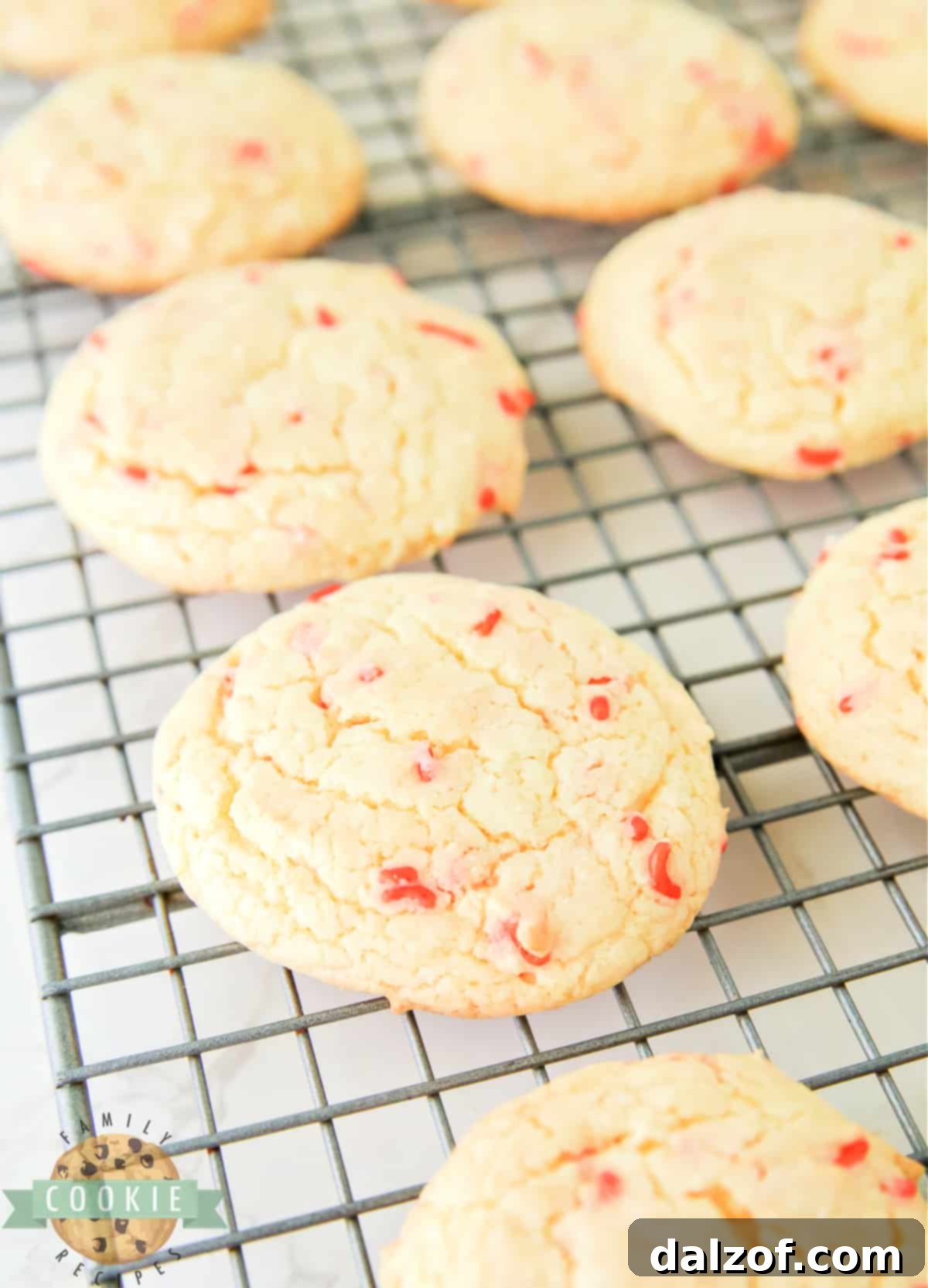 Freshly baked cake mix cookies, still warm, with visible sprinkles on a baking sheet.