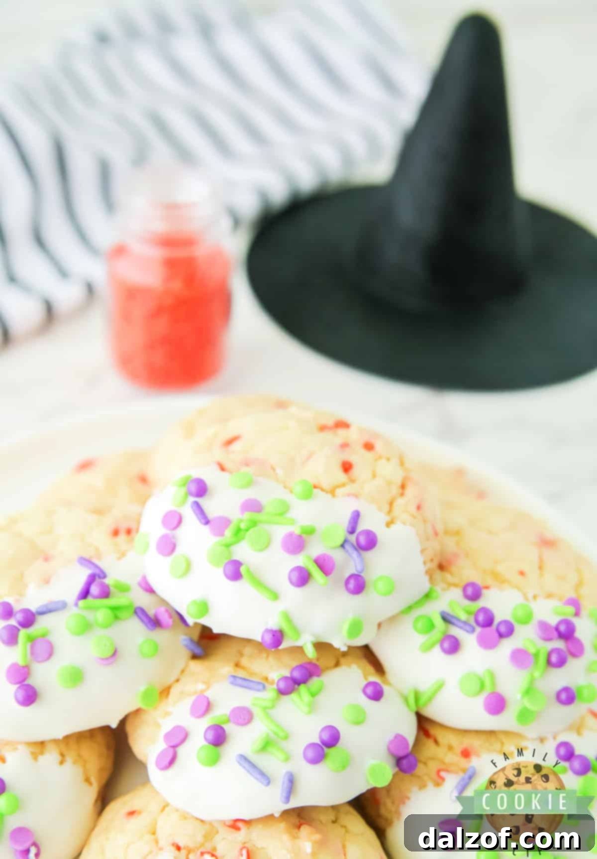 A trio of Halloween Cake Mix Sprinkle Cookies, perfectly frosted and decorated, ready for a spooky snack.