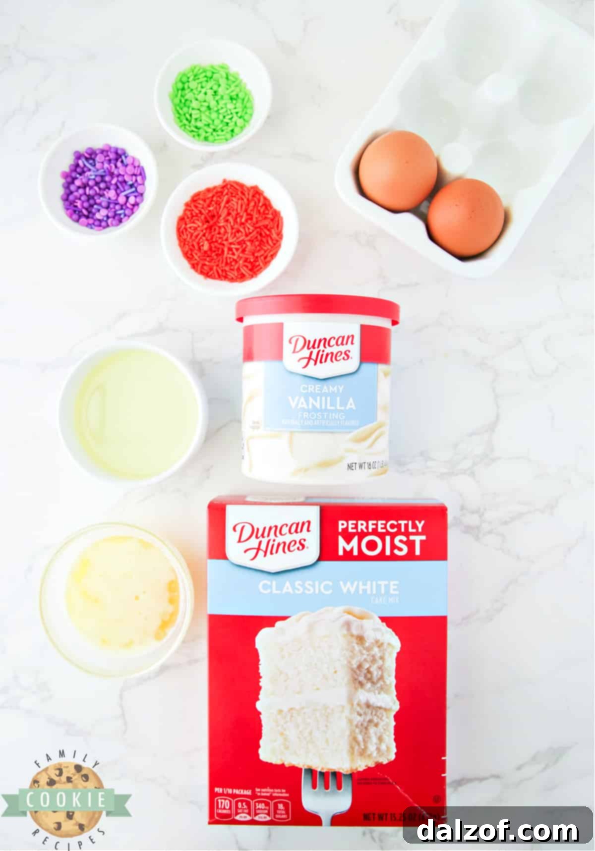 Essential ingredients laid out for Halloween Cake Mix Sprinkle Cookies: a box of white cake mix, oil, butter, eggs, vanilla frosting, and colorful sprinkles.