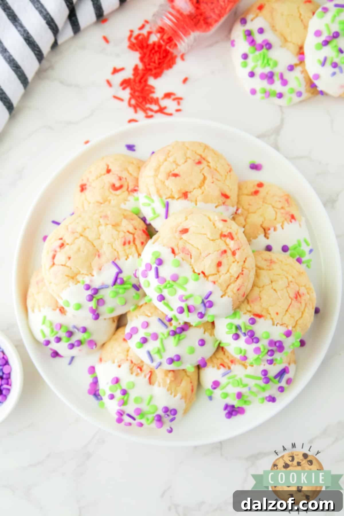 Close-up of a stack of Halloween Cake Mix Sprinkle Cookies, showcasing their vibrant frosting and festive sprinkles, ready to be enjoyed.