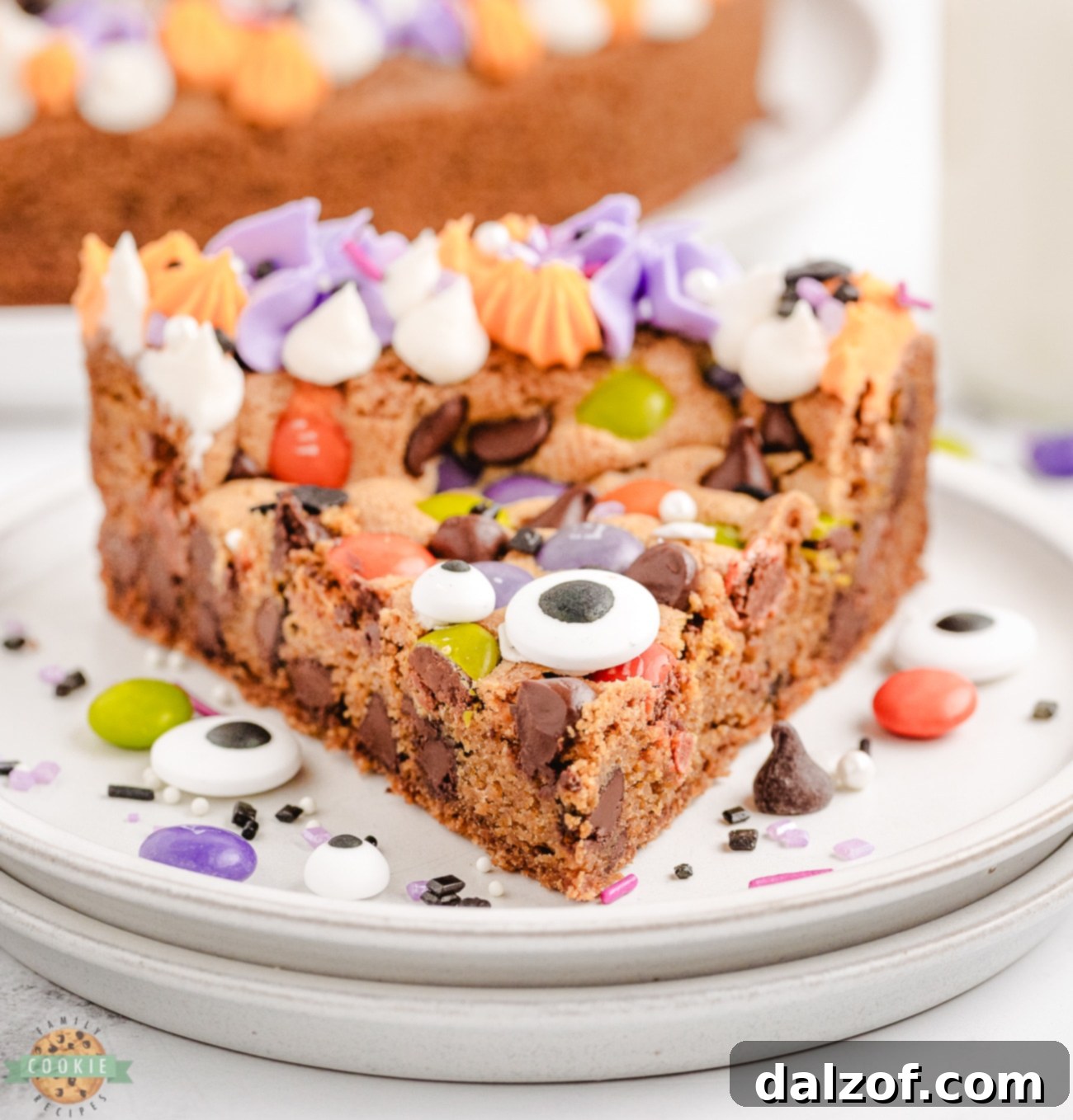 slice of Halloween cookie cake with candy eyeballs on top