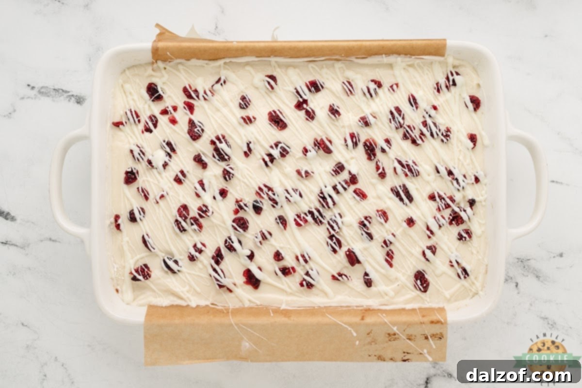 Add white chocolate drizzle on top of frosted cookie bars. 