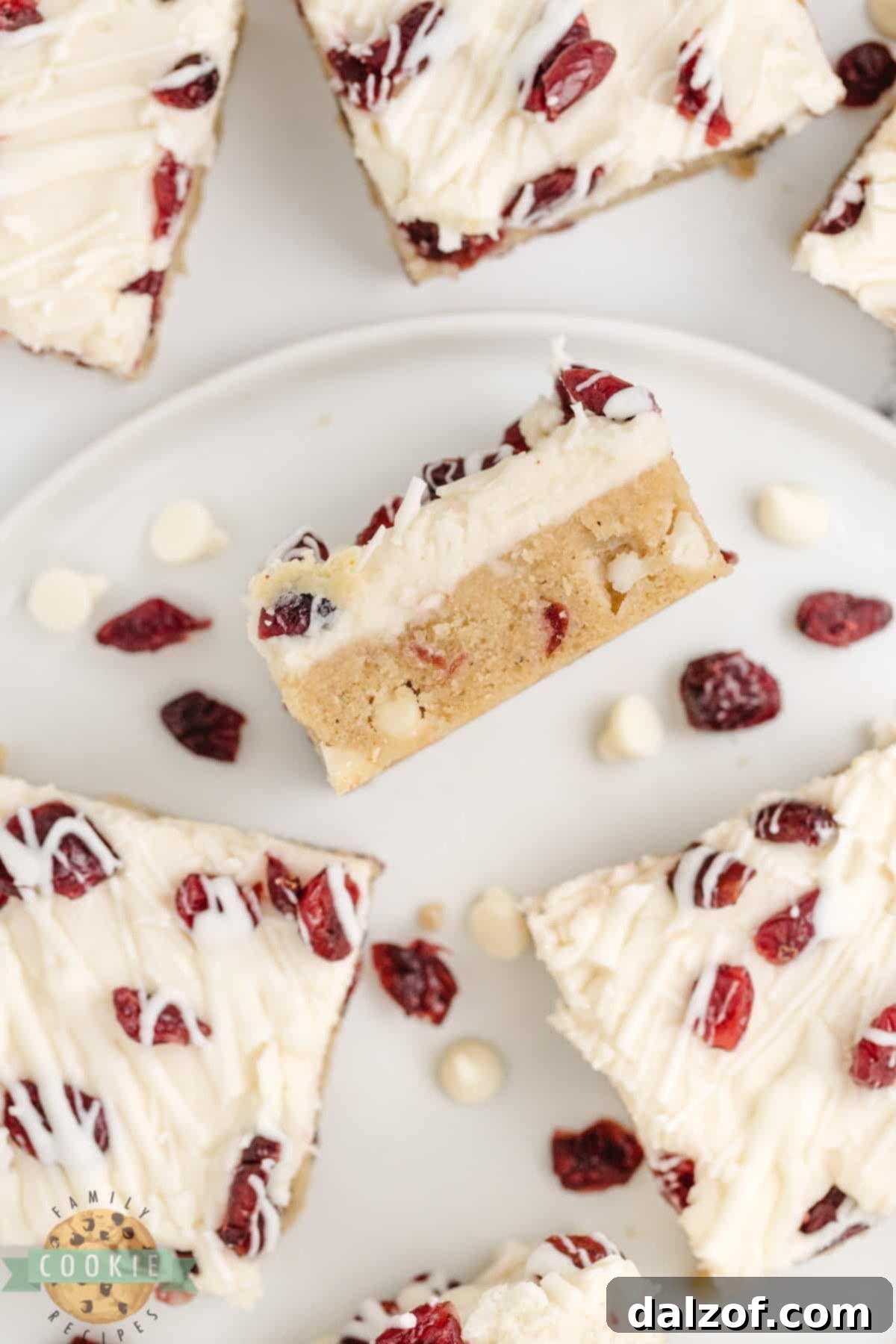 White Chocolate Cranberry Cookie Bars are soft, chewy, and covered with cream cheese frosting and a white chocolate drizzle. This is a fantastic cookie bar recipe that is perfect for fall!