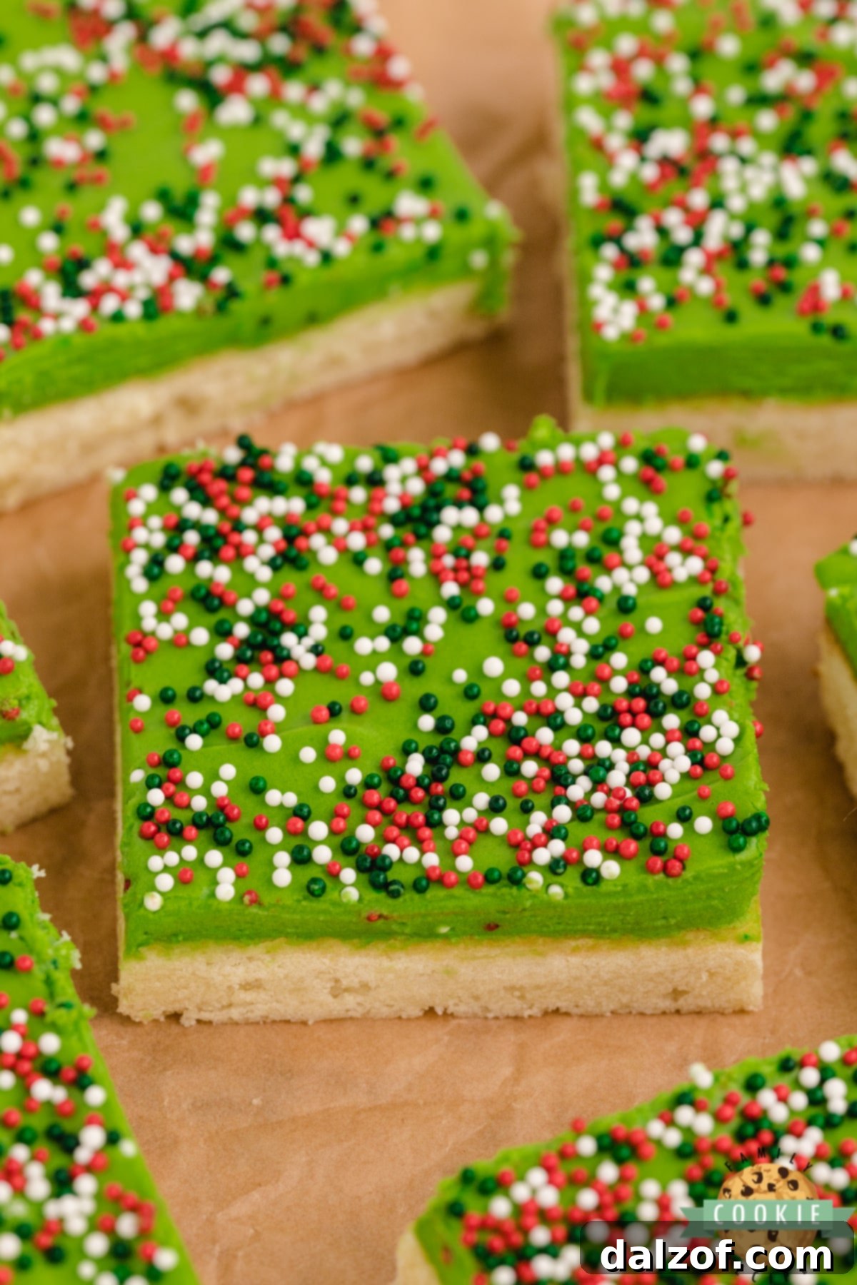 Thick, soft and chewy sugar cookie bar recipe with holiday frosting