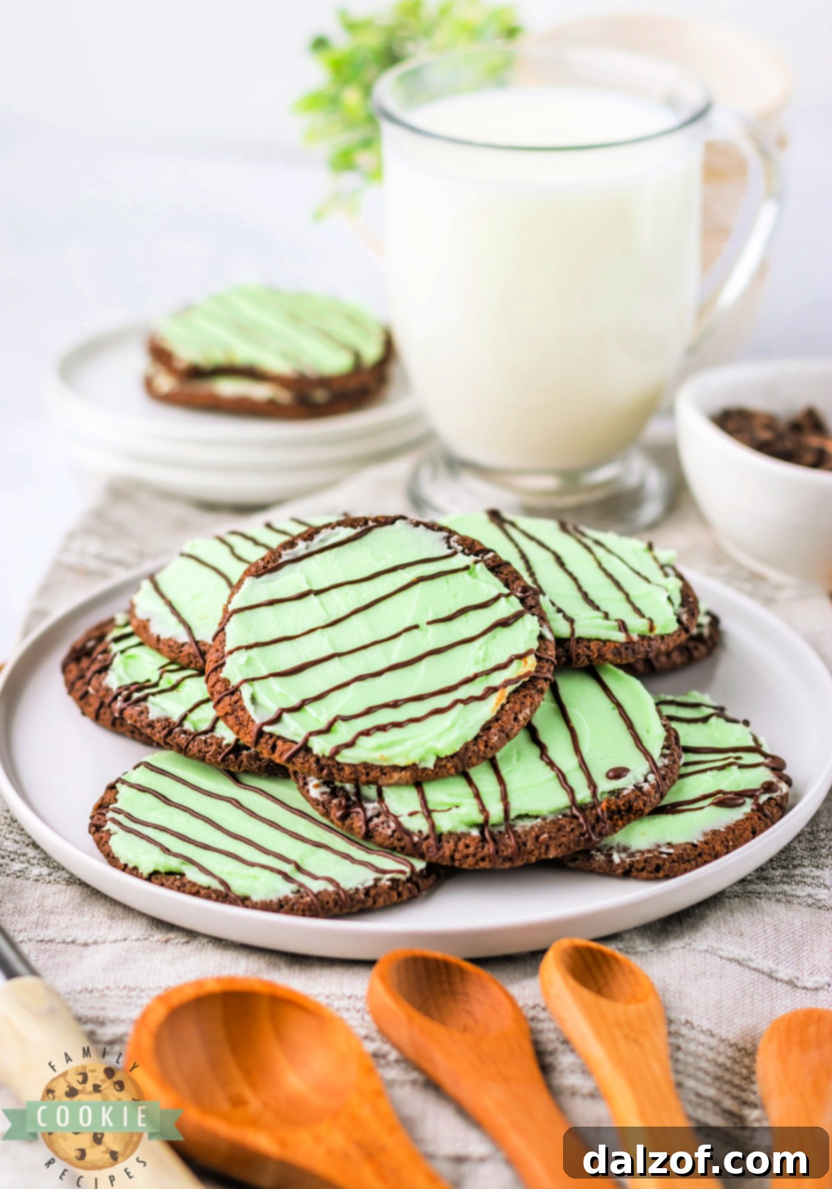 A beautifully arranged plate of Frosted Mint Chocolate Cookies, showcasing their appealing green frosting and chocolate drizzle, ready for serving.