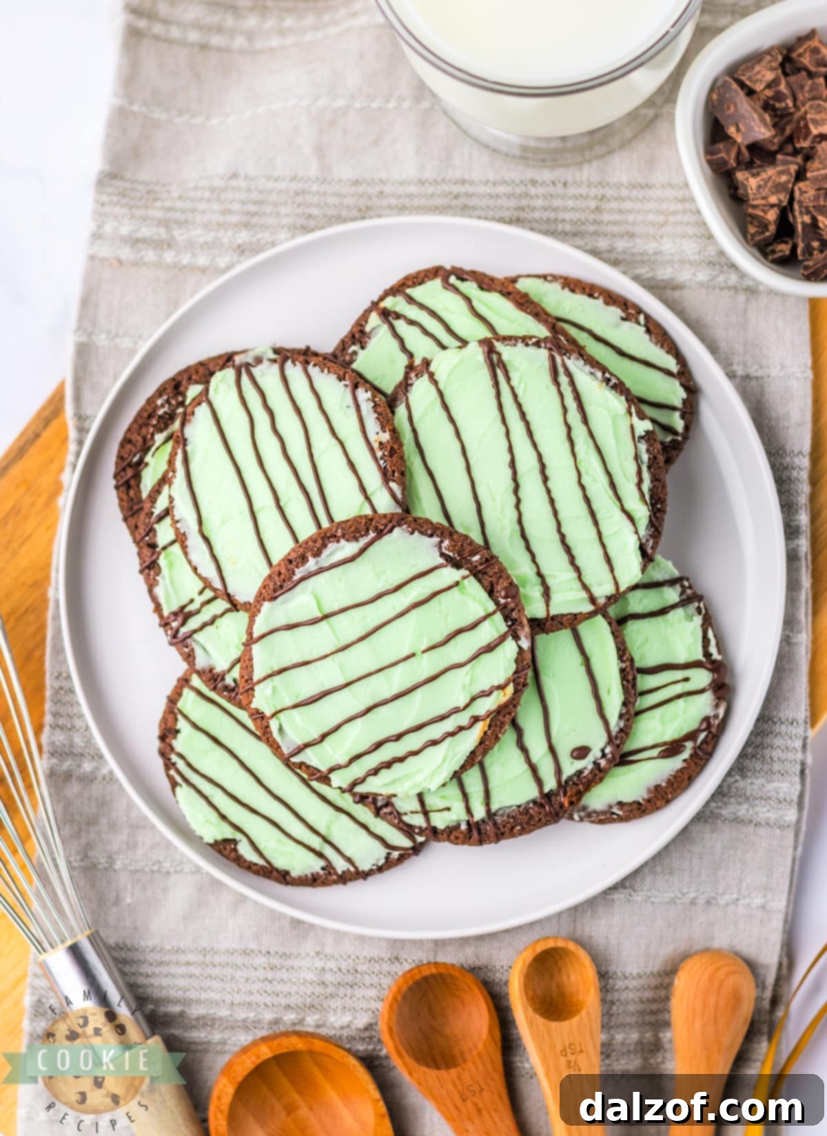 Frosted Mint Chocolate Cookies, beautifully garnished with mint frosting and chocolate drizzle, arranged on a plate.