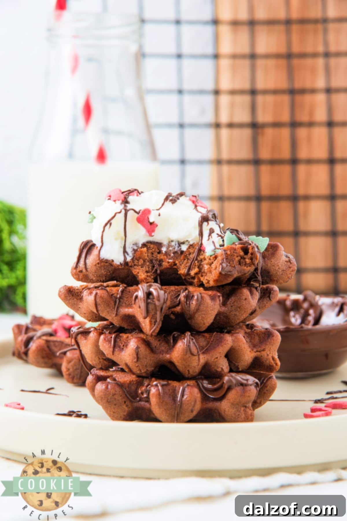A vibrant display of decorated chocolate waffle cookies for Christmas.