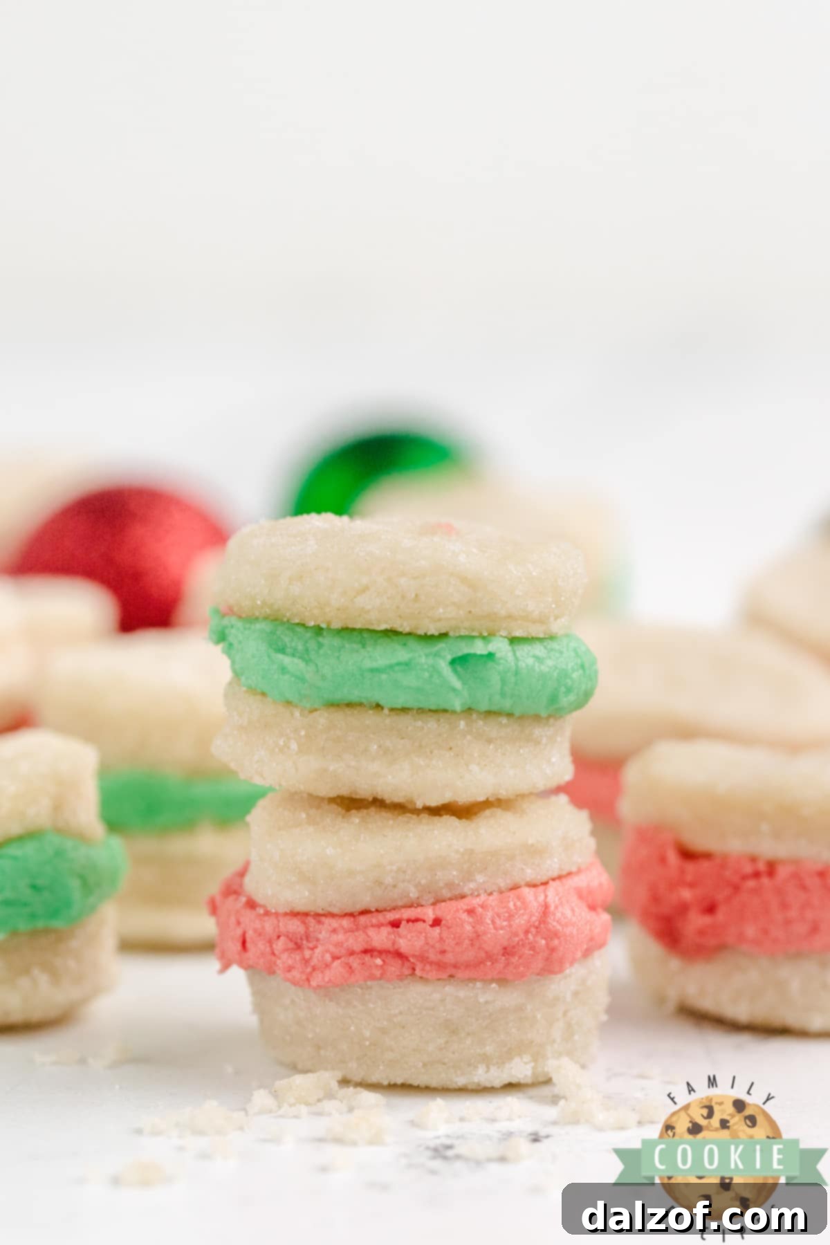 Close-up of delectable shortbread cookie sandwiches with vibrant buttercream frosting, a perfect holiday dessert.