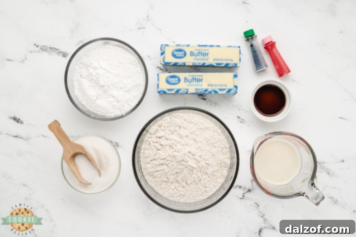 Key ingredients for Mini Christmas Sandwich Cookies laid out on a baking surface, including butter, flour, and sugar.