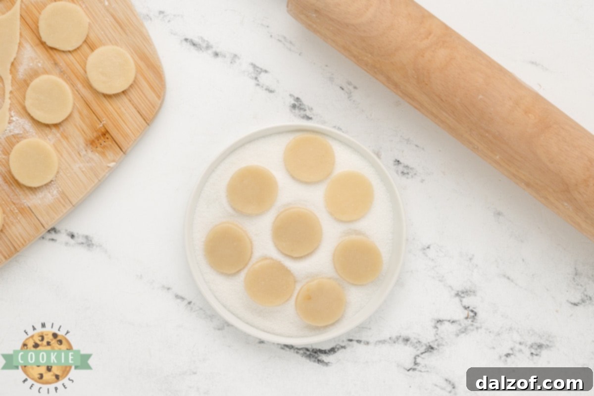 Uniformly coated cookie dough in granulated sugar, ready for baking.