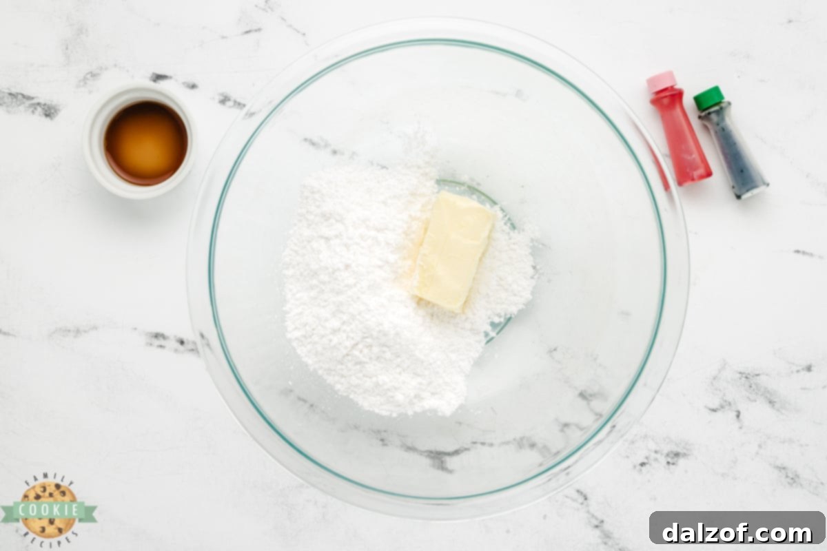 Softened butter and powdered sugar being creamed together in a bowl for the frosting.
