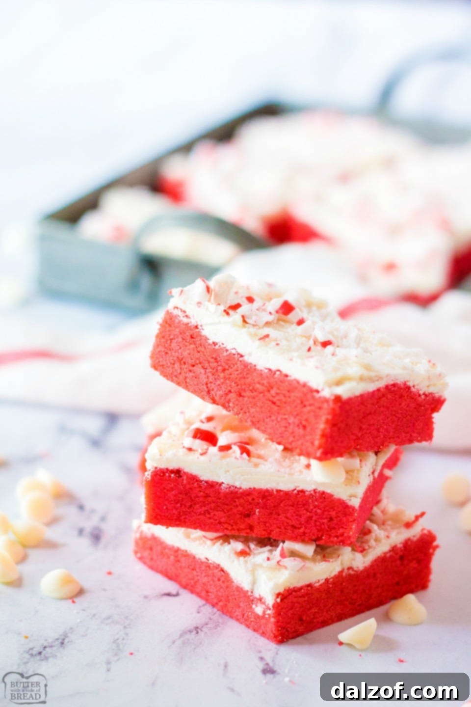 Frosted Peppermint Cookie Bars, an easy holiday sugar cookie bar recipe topped with white chocolate and crushed peppermints, perfect for Christmas baking.
