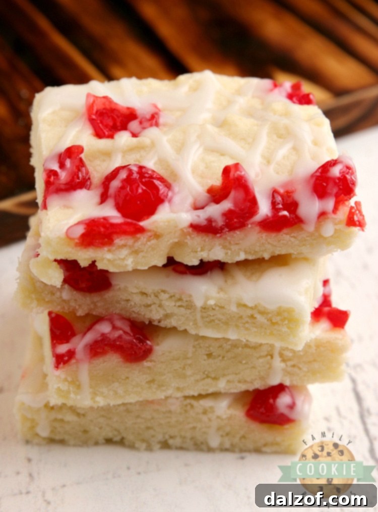 Delicious Cherry Almond Cookie Bars with a rich glaze and chopped cherries, ready to be served.