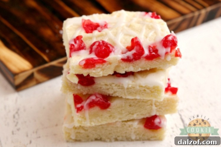 Stacked Cherry Almond Cookie Bars showcasing their soft texture and beautiful glaze, ready for storage or serving.