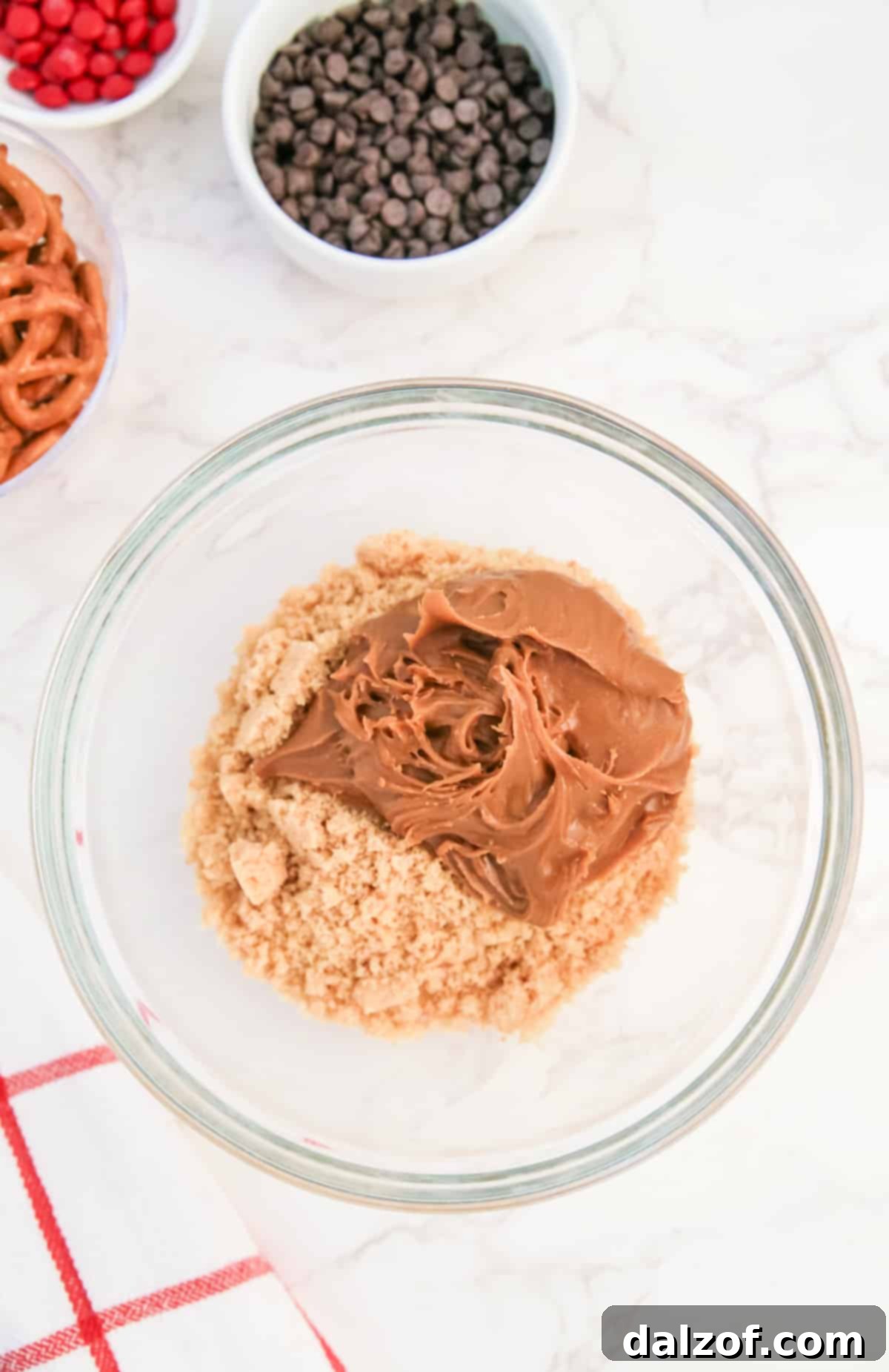 Rudolph's Red-Nosed Cookie Butter Delights 6 Mixing crushed Nilla wafers with cookie butter to create the base for festive Rudolph treats.