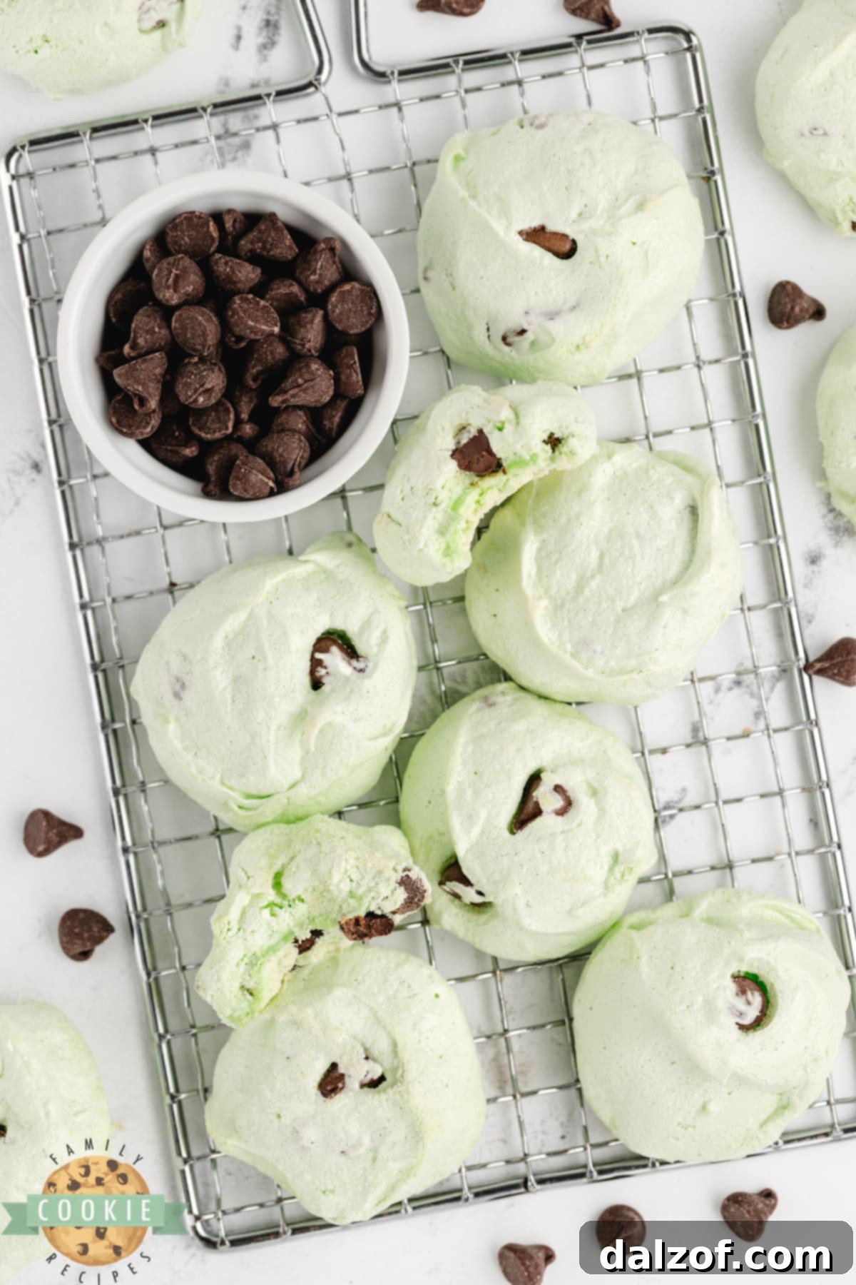 Freshly baked Mint Chocolate Chip Meringue Cookies cooling on a wire rack, showcasing their perfect shape and texture.