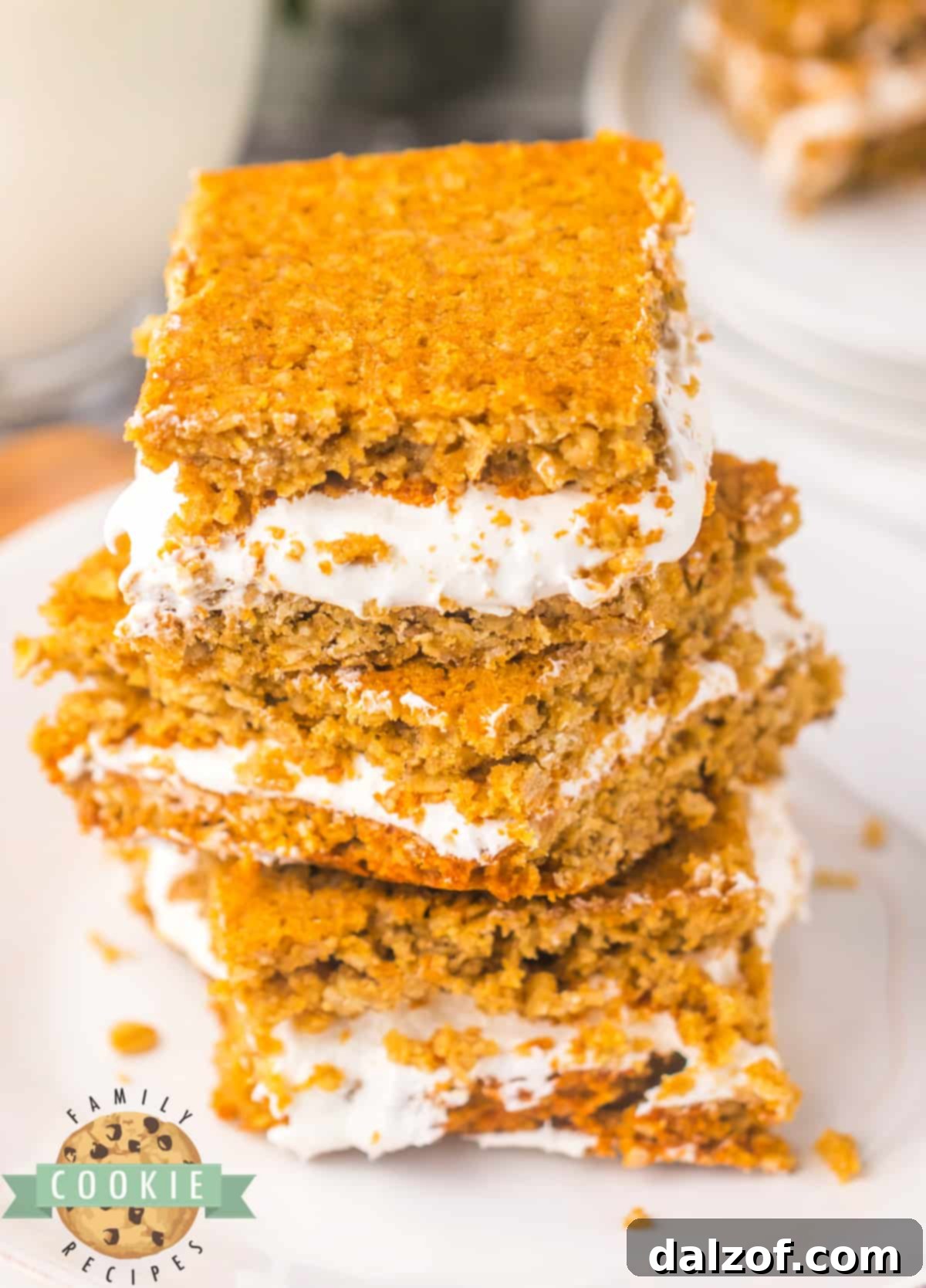 Close-up of oatmeal sandwich cookie bars with a thick, creamy marshmallow filling, ready to eat.