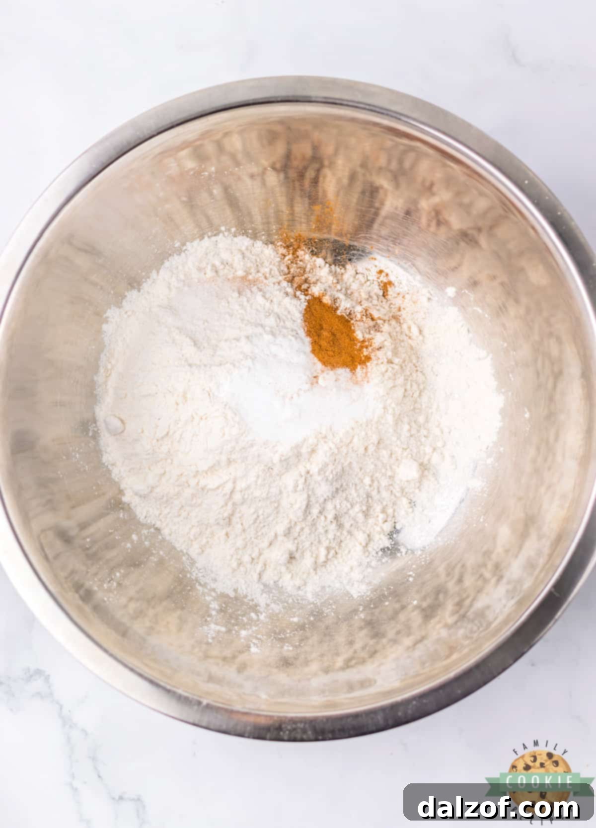 Mixing dry ingredients: flour, cinnamon, salt, and baking soda in a separate bowl.