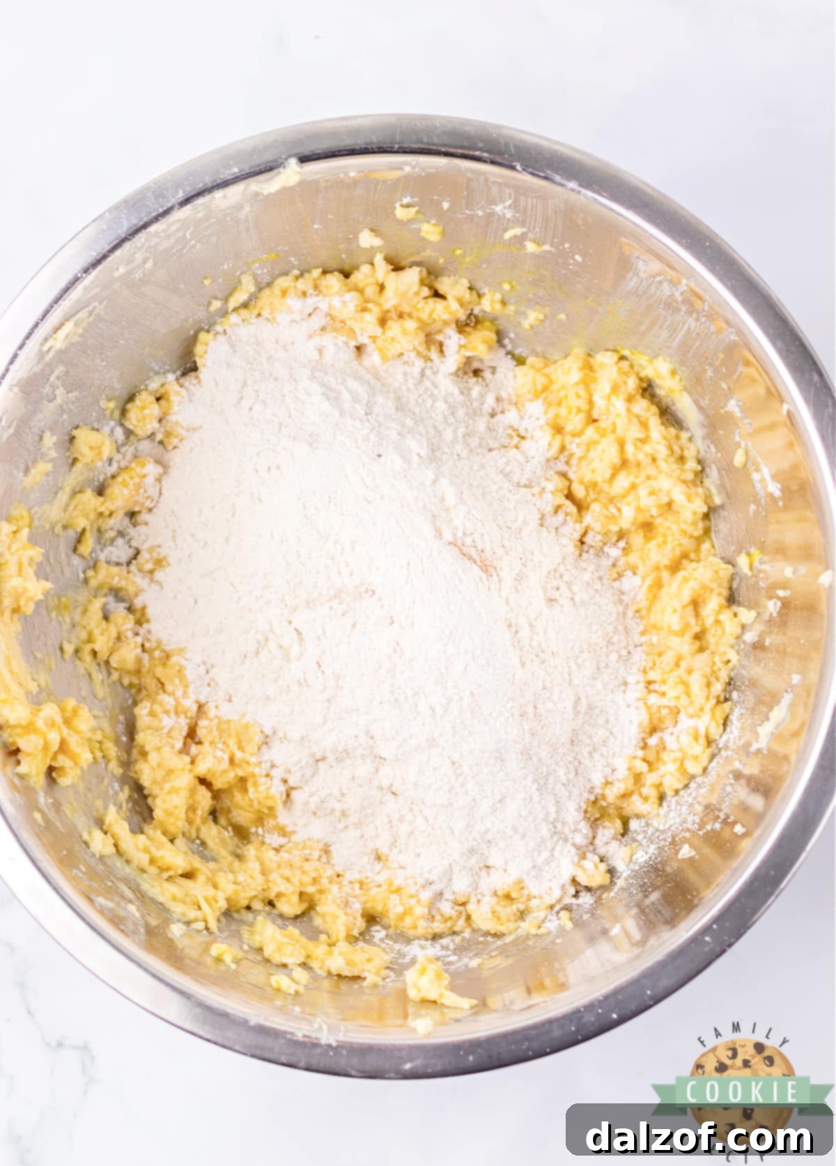 Adding the prepared dry ingredients into the wet butter and sugar mixture, mixing until just combined.