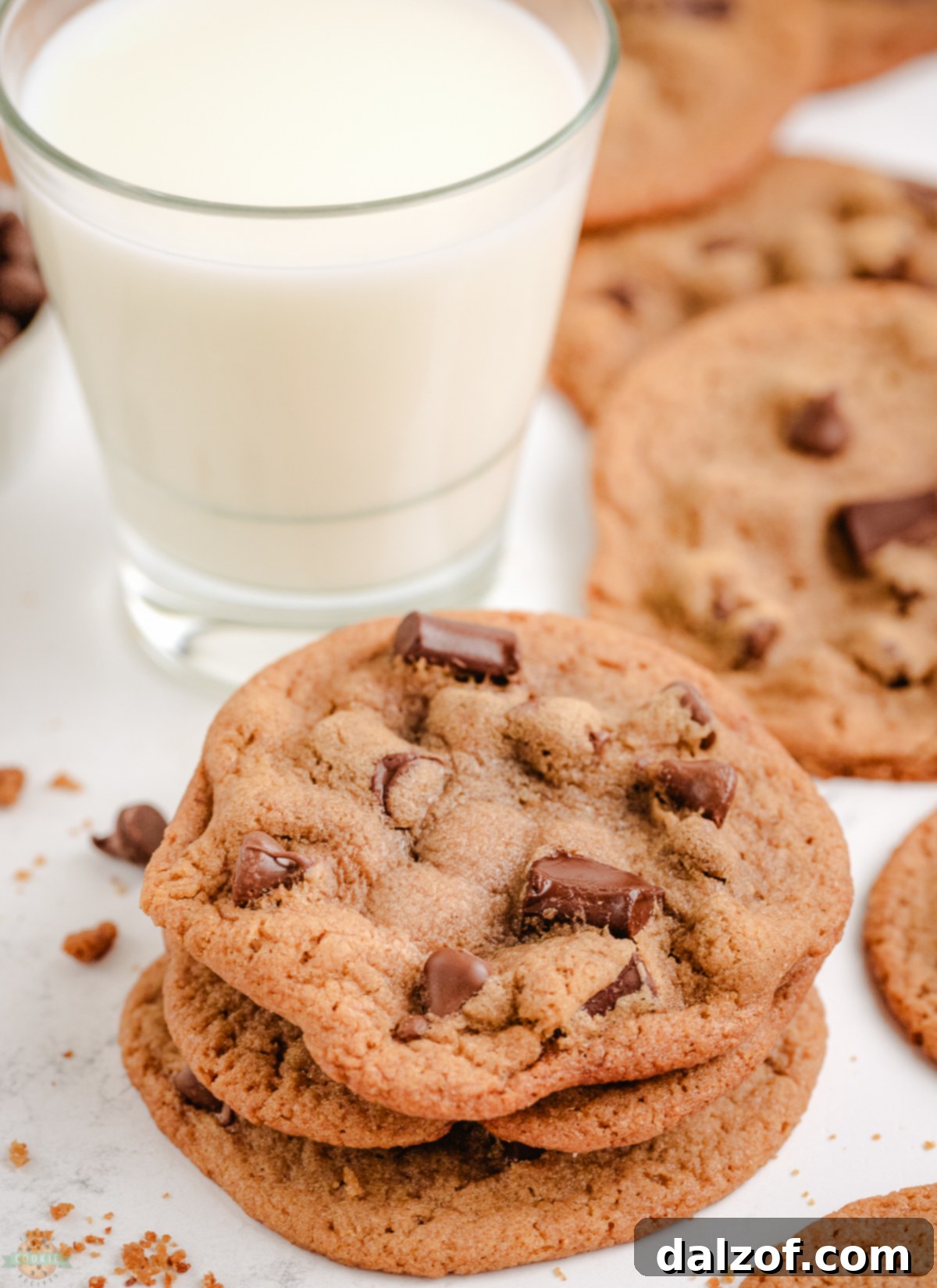 Stack of malt chocolate chip cookies with a refreshing glass of milk
