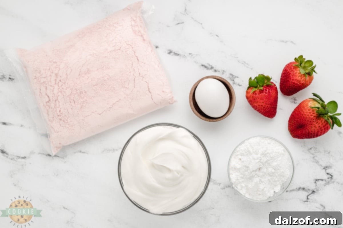 A bowl of thawed Cool Whip, an egg, and a box of strawberry cake mix, the three main ingredients for these easy cookies.