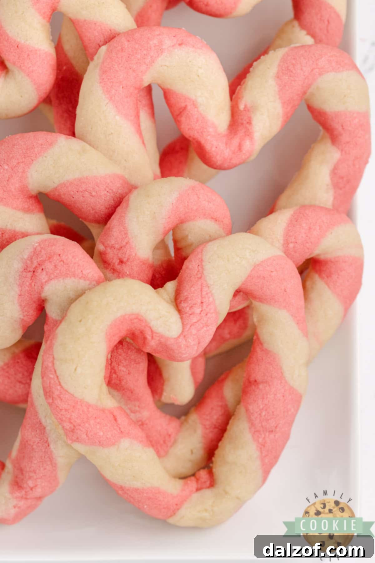 Beautiful Braided Sweetheart Cookies with pink and white stripes, perfect for Valentine's Day celebrations or as a charming gift. These easy-to-make heart-shaped sugar cookies feature a unique twisted design and require no frosting.