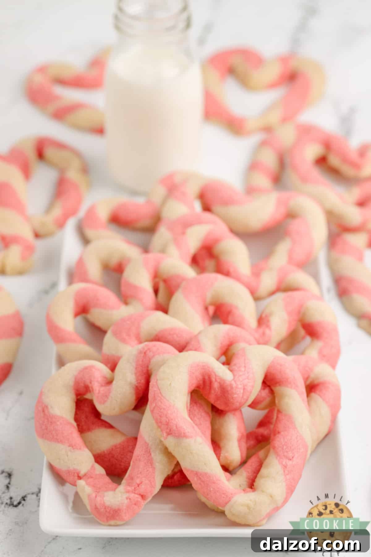 Freshly baked Braided Sweetheart Cookies arranged appealingly, showcasing their beautiful pink and white twisted heart shapes.