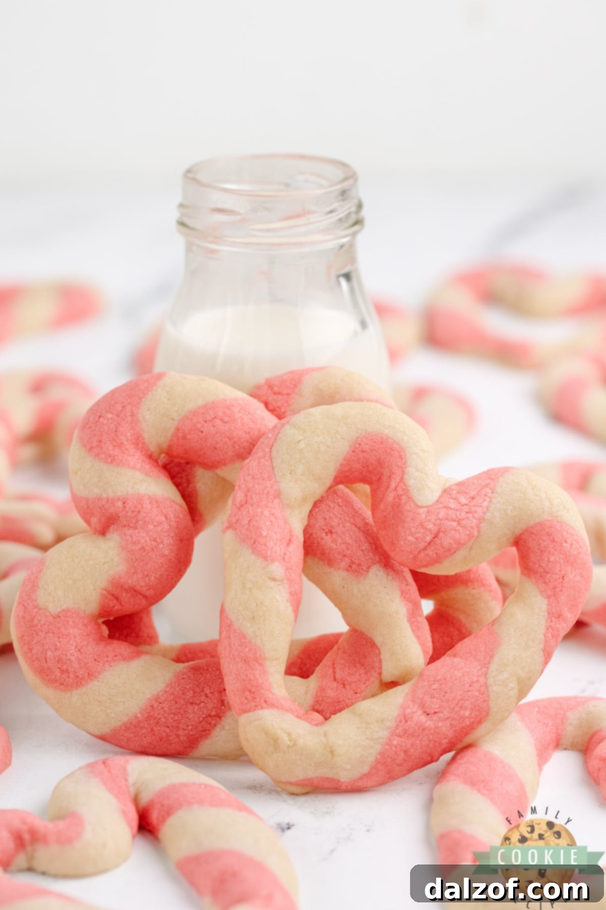 An array of delicate heart shaped cookies, each showcasing the charming pink and white braided effect.